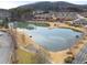 Aerial view of the community pond surrounded by lush trees, walking path, and well-maintained landscaping at 348 Lauren Ln, Woodstock, GA 30188