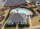 Aerial view of a kidney-shaped pool surrounded by lounge chairs and community buildings at 348 Lauren Ln, Woodstock, GA 30188