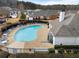 Aerial view of a kidney-shaped pool surrounded by lounge chairs in a residential community at 348 Lauren Ln, Woodstock, GA 30188