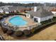 Aerial view of a kidney-shaped pool surrounded by lounge chairs and a building at 348 Lauren Ln, Woodstock, GA 30188