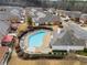 Aerial view of a kidney-shaped pool, chairs, and nearby homes in a residential community at 348 Lauren Ln, Woodstock, GA 30188