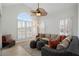 Bright sunroom featuring wicker seating, a ceiling fan, and large windows with plantation shutters at 348 Lauren Ln, Woodstock, GA 30188