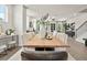 Dining area with a large wooden table, comfortable seating, and modern decor adjacent to the living room at 401 Nix Ln, Lawrenceville, GA 30046