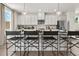 Modern kitchen with white cabinets, stainless steel appliances, stylish pendant lights, and breakfast bar seating at 401 Nix Ln, Lawrenceville, GA 30046