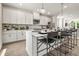 Bright kitchen boasts a large island, modern appliances, white cabinetry, and stylish pendant lighting at 401 Nix Ln, Lawrenceville, GA 30046