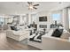 Open living room and kitchen layout with white cabinets, hardwood floors, and a ceiling fan for added comfort at 401 Nix Ln, Lawrenceville, GA 30046