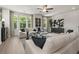 Bright living room with neutral tones, offering ample seating, a ceiling fan, and natural light at 401 Nix Ln, Lawrenceville, GA 30046