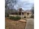 Charming ranch-style home with a stone chimney and a welcoming covered front porch at 582 S Cherokee Rd, Social Circle, GA 30025