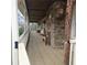 Cozy covered porch with stone detail, swing, seating, and wood columns at 582 S Cherokee Rd, Social Circle, GA 30025