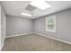 Spacious bedroom with carpet and a ceiling fan with neutral paint and a large window at 587 Morgan Ct, Hampton, GA 30228