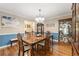 Elegant dining room with hardwood floors, a large window, and classic furniture at 587 Morgan Ct, Hampton, GA 30228