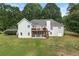 Back exterior view showcasing a two-story home with a deck and walkout basement at 587 Morgan Ct, Hampton, GA 30228