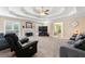 Bright living room featuring a fireplace, tray ceilings, neutral paint and plush carpeting at 587 Morgan Ct, Hampton, GA 30228