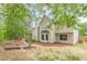Backyard view featuring a two-story home with well-maintained landscaping and a lush wooded perimeter at 105 Kentwood Springs Dr, Hampton, GA 30228
