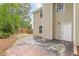 A view of the backyard with a small concrete patio and wooden fence at 105 Kentwood Springs Dr, Hampton, GA 30228