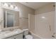 A well-lit bathroom features a granite countertop, vanity and a shower-tub combo for convenience at 105 Kentwood Springs Dr, Hampton, GA 30228