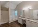 Primary bathroom featuring double sink vanity, soaking tub, and shower for a luxurious experience at 105 Kentwood Springs Dr, Hampton, GA 30228