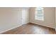 Cozy bedroom with hardwood floors, a vaulted ceiling, and an arched window at 105 Kentwood Springs Dr, Hampton, GA 30228
