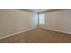 A sunlit bedroom features neutral carpeting and a window creates a warm, comfortable space at 105 Kentwood Springs Dr, Hampton, GA 30228