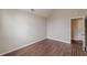 Bedroom with hardwood floors, neutral walls, and a door leading to the hallway at 105 Kentwood Springs Dr, Hampton, GA 30228