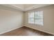 A cozy bedroom features modern flooring and a window for natural light, enhancing the peaceful ambiance at 105 Kentwood Springs Dr, Hampton, GA 30228