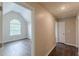 Bedroom with vaulted ceiling, large arched window, and hardwood floors at 105 Kentwood Springs Dr, Hampton, GA 30228