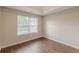 A bright bedroom featuring modern flooring and a window with natural light creates an inviting atmosphere at 105 Kentwood Springs Dr, Hampton, GA 30228