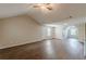 Expansive bonus room boasts wood-look flooring, ceiling fan, and generous natural light for added comfort at 105 Kentwood Springs Dr, Hampton, GA 30228