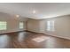 Large bonus room with wood-look floors and ample natural light presents a flexible and welcoming space at 105 Kentwood Springs Dr, Hampton, GA 30228