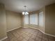 Dining area with tile flooring, a chandelier, and large windows at 105 Kentwood Springs Dr, Hampton, GA 30228