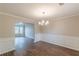 Beautiful dining room with wainscoting, hardwood floors, and a view into the living spaces at 105 Kentwood Springs Dr, Hampton, GA 30228