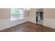 Dining room showcasing wainscoting, chandelier, hardwood floors, and natural light at 105 Kentwood Springs Dr, Hampton, GA 30228