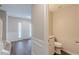 Inviting entryway featuring hardwood floors, a white front door, and a convenient powder room at 105 Kentwood Springs Dr, Hampton, GA 30228