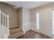 Foyer featuring stairway, wainscoting, and neutral paint, leading to the upper levels at 105 Kentwood Springs Dr, Hampton, GA 30228