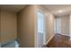 Bright hallway with hardwood floors, open doorways, and ample natural light at 105 Kentwood Springs Dr, Hampton, GA 30228