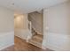 Inviting hallway features staircase, warm paint, wainscoting, and durable laminate flooring at 105 Kentwood Springs Dr, Hampton, GA 30228