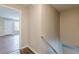 Hallway with hardwood floors and neutral walls leads to other areas of the home at 105 Kentwood Springs Dr, Hampton, GA 30228