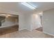 Hallway with tile flooring leading to carpeted living area and staircase at 105 Kentwood Springs Dr, Hampton, GA 30228