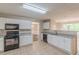 Bright kitchen with granite countertops, white cabinets, and stainless steel appliances at 105 Kentwood Springs Dr, Hampton, GA 30228