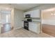 Well-lit kitchen featuring tile floors, white cabinets, granite countertops, and modern appliances at 105 Kentwood Springs Dr, Hampton, GA 30228