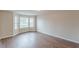 Inviting living room featuring hardwood floors and a corner filled with bright windows at 105 Kentwood Springs Dr, Hampton, GA 30228