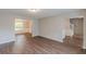 Spacious living room featuring hardwood floors and a staircase leading to the upper level at 105 Kentwood Springs Dr, Hampton, GA 30228