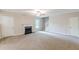 Large carpeted living room featuring a fireplace, ceiling fan, and a staircase at 105 Kentwood Springs Dr, Hampton, GA 30228