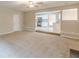 Spacious carpeted living room with an entryway and a view of the modern kitchen at 105 Kentwood Springs Dr, Hampton, GA 30228