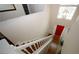 Bright foyer with hardwood floors, grand staircase, high ceilings and a vibrant red front door visible from the second story at 11532 Ethan Ct, Hampton, GA 30228