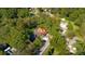 Aerial view showcasing the charming home nestled among mature trees with lush green surroundings at 116 Tallapoosa St, Temple, GA 30179