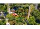 Aerial view of a home on a .5 acre lot with surrounding mature trees and red boundary lines at 116 Tallapoosa St, Temple, GA 30179