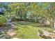 Fenced backyard featuring a brick-lined walkway and lush green lawn, creating a private outdoor space at 116 Tallapoosa St, Temple, GA 30179