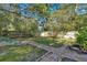Private backyard featuring a wooden fence, lush greenery, and decorative brick pavers at 116 Tallapoosa St, Temple, GA 30179