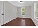 Bedroom features hardwood floors, neutral paint, white trim, natural light and two closets at 116 Tallapoosa St, Temple, GA 30179